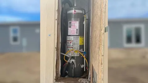 Gas water heater inspection in a utility room for Castle Rock Plumbing Blog