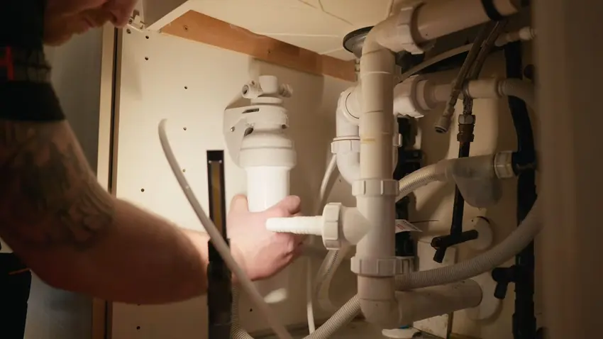 Plumbing repair work with tools and exposed piping for Plumber in Franktown, CO